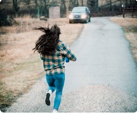 Child running along an outdoor path